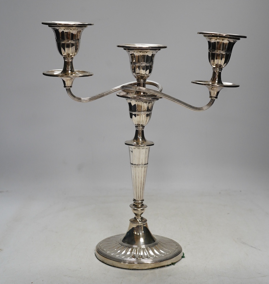 A late Victorian silver two branch, three light candelabrum, Edward Hutton, London, 1891, height 30.7cm, weighted. Condition - fair